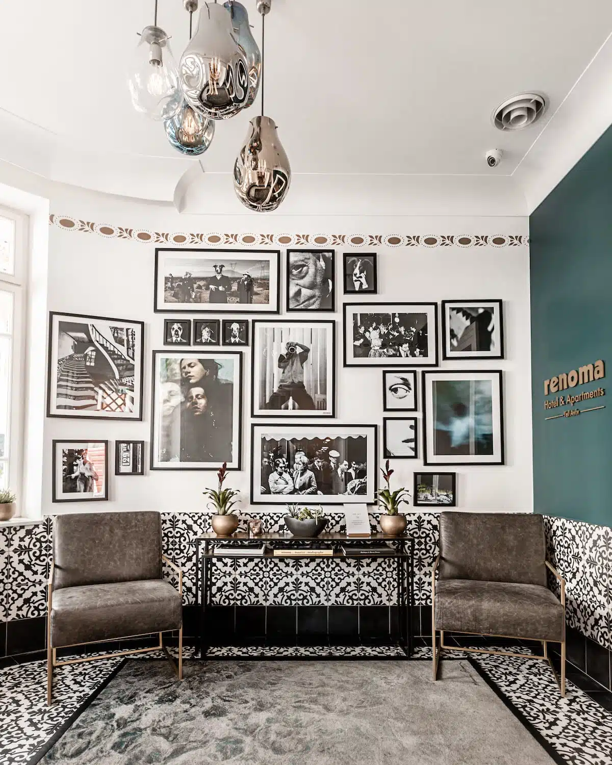 Renoma lobby gallery wall with curated black-and-white photography and designer seating