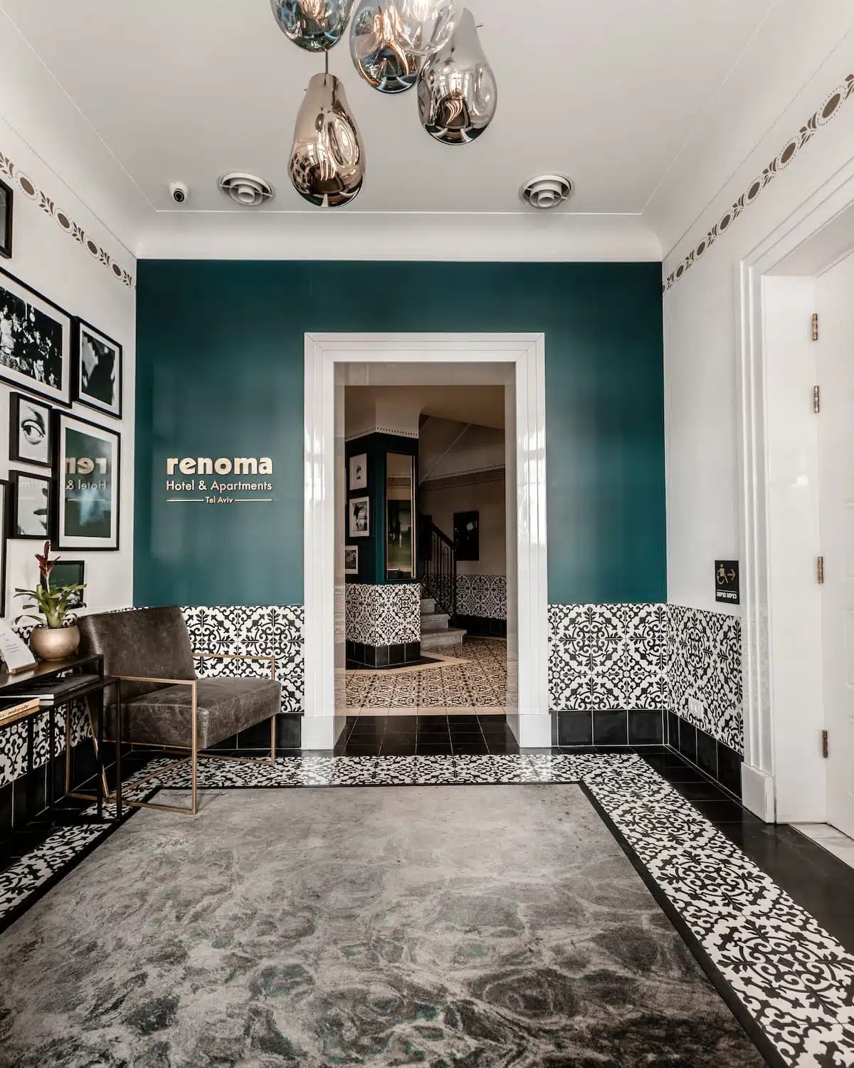 Renoma hotel lobby with teal accent wall, patterned tiles and designer lighting